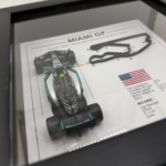 Black-framed Kimi Antonelli Miami GP 2026 artwork with a miniature racing car on the left, raised Miami circuit, United States flag and race information.
