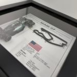 Black-framed Kimi Antonelli Miami GP 2026 artwork with a miniature racing car on the left, raised Miami circuit, United States flag and race information.